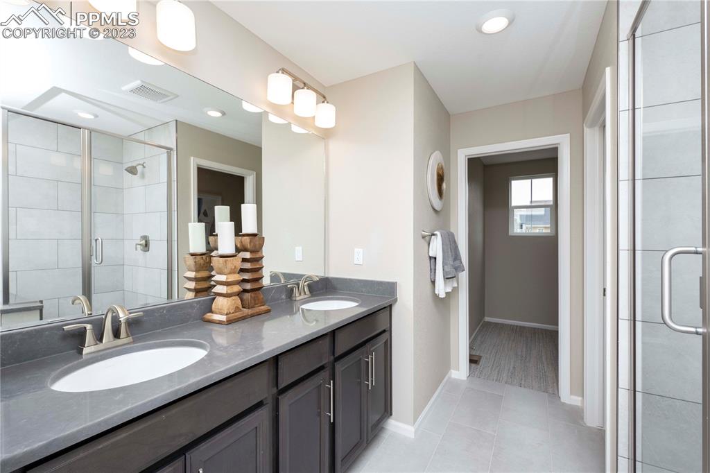 631 Felicity Loop Castle Rock, CO 80109 - Photo 23 of 33 a bathroom with a granite countertop sink mirror and double