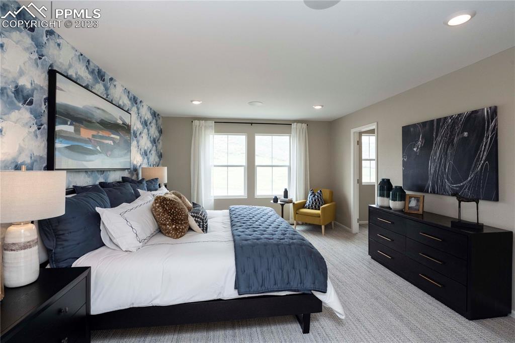 631 Felicity Loop Castle Rock, CO 80109 - Photo 26 of 33 a bedroom with a bed and wooden floor