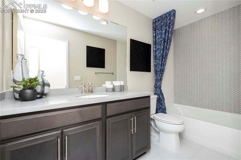 631 Felicity Loop Castle Rock, CO 80109 - Photo 27 of 33 a bathroom with a sink a toilet and a large mirror