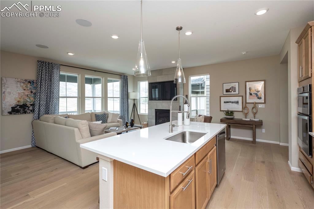 631 Felicity Loop Castle Rock, CO 80109 - Photo 8 of 33 a view of kitchen island a sink and living room