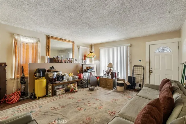 a living room with furniture a window and gym equipment
