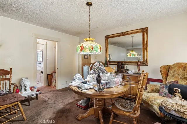 a view of a dining room with furniture and a chandelier
