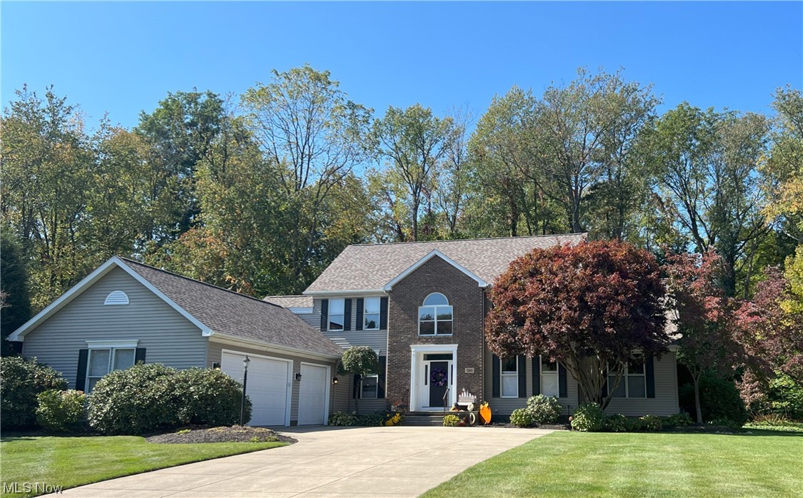 View of front of house with a garage and a front yard