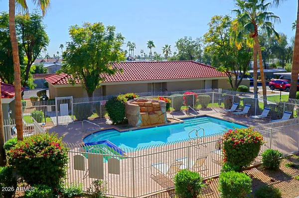 a view of a house with backyard and a patio