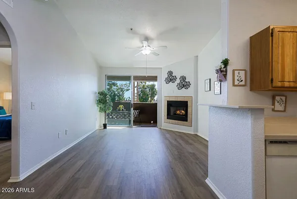 a view of a hallway with a fireplace and a window