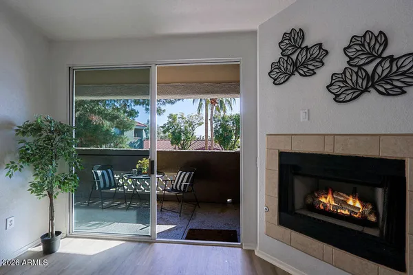a living room with a fireplace and a floor to ceiling window