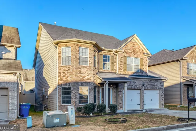 a front view of a house with garden