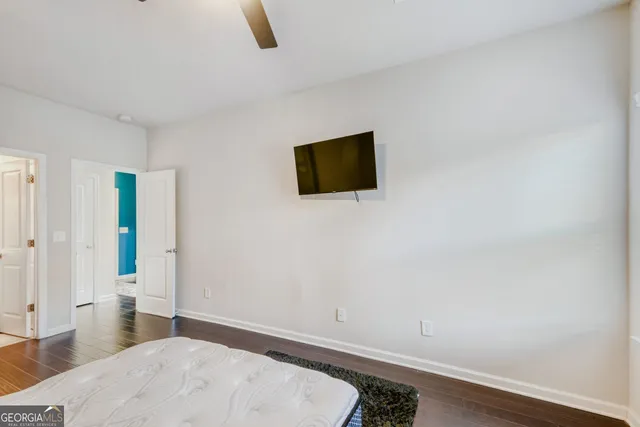 a room with a bed and a flat screen tv