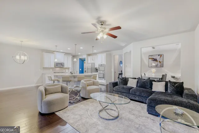 a living room with furniture and a wooden floor