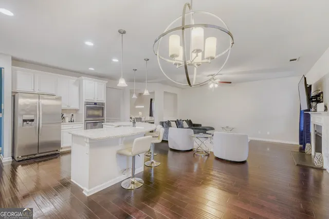 a large kitchen with a table chairs and a refrigerator