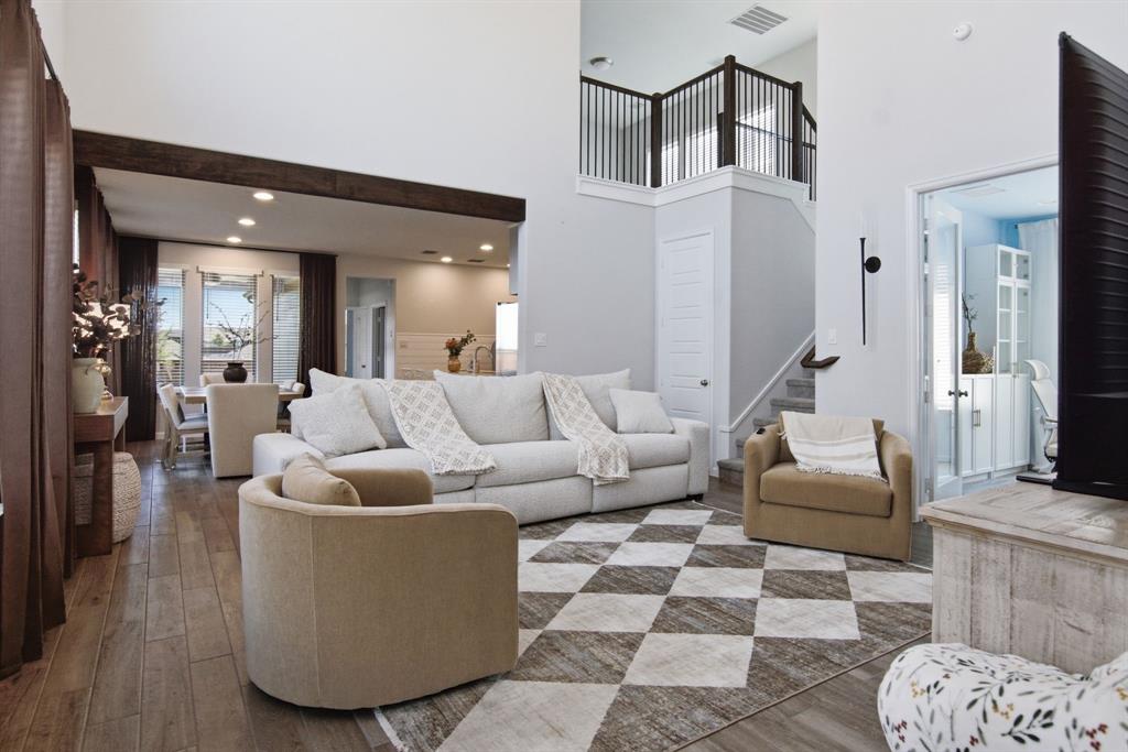 201 Pintail Lane Rhome, TX 76078 - Photo 6 of 36 Spacious living area featuring high ceilings, wood-finish flooring, and a decorative exposed beam