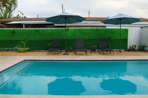 a view of a swimming pool with an outdoor space and seating area