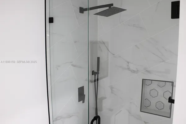 a bathroom with a shower and a sink