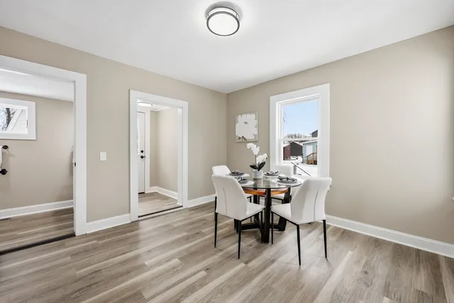 a view of a dining room with furniture and wooden floor