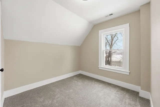 a view of a white house with a snow on the road