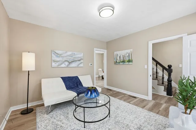 a living room with furniture and a potted plant