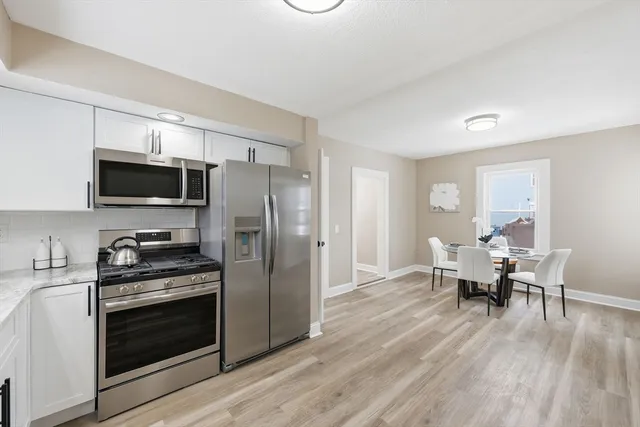 a stove top oven sitting inside of a kitchen