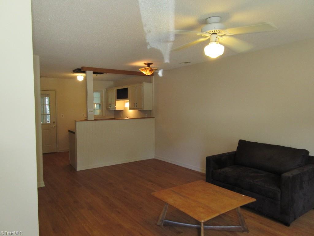 245 Hampton Road, Unit 3B Asheboro, NC 27203 - Photo 2 of 18 Living space and dining area half open to the kitchen. Nice tiffany style lamp and ceiling fans!