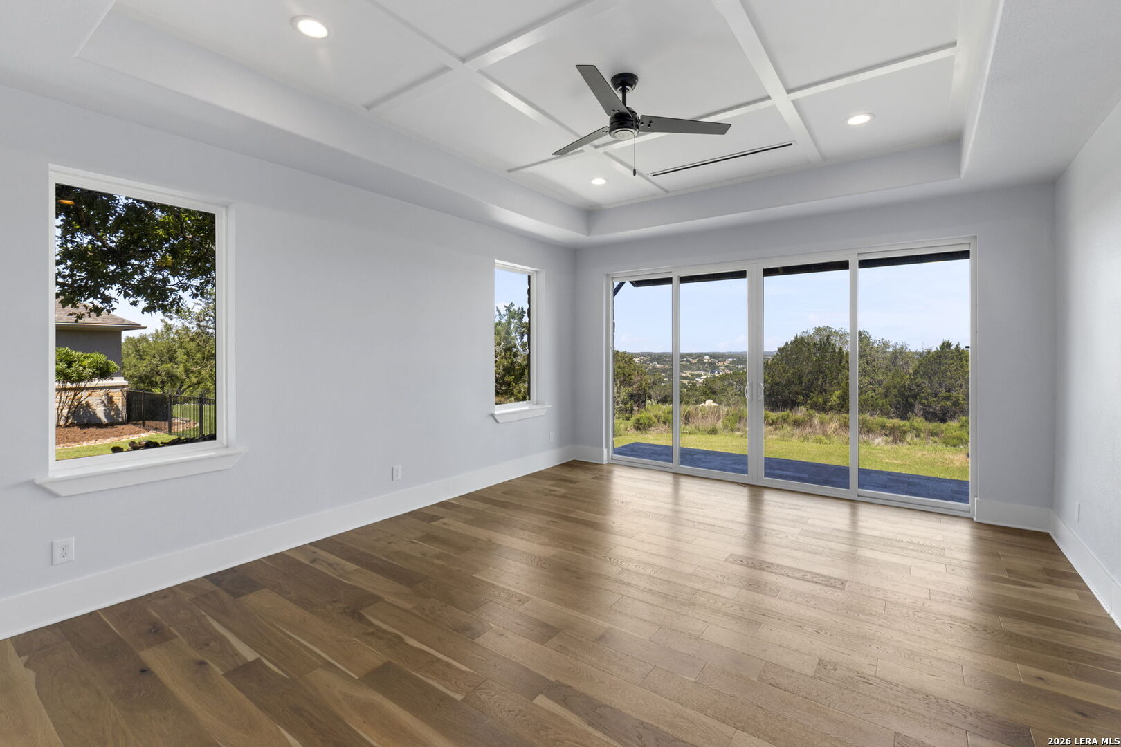 1054 Star Ridge Spring Branch, TX 78070 - Photo 14 of 31 a view of an empty room with a window and wooden floor