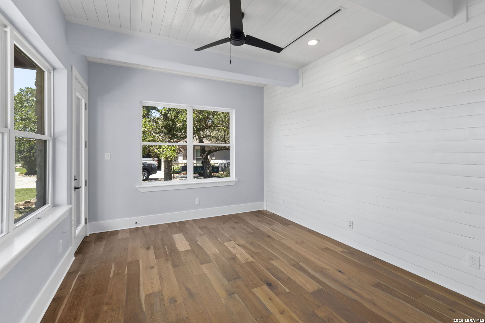 1054 Star Ridge Spring Branch, TX 78070 - Photo 5 of 31 a view of an empty room with wooden floor and a window