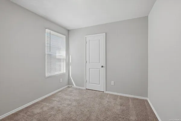 an empty room with windows and closet