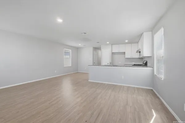 a view of kitchen with wooden floor and electronic appliances