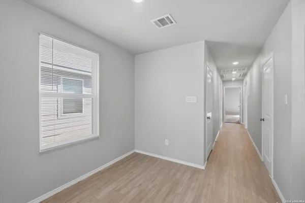 a view of a room with wooden floor and windows