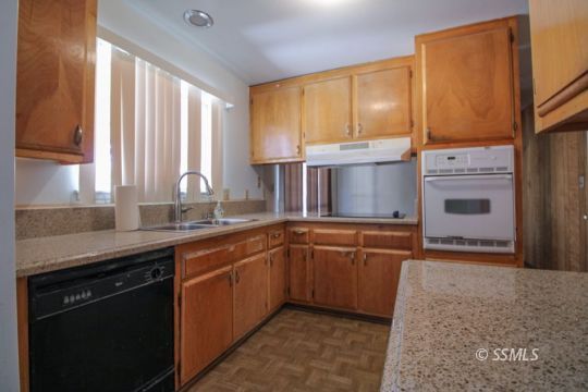 537 South Fairview Street Ridgecrest, CA 93555 - Photo 9 of 35 a kitchen with granite countertop cabinets stainless steel appliances a sink and a window