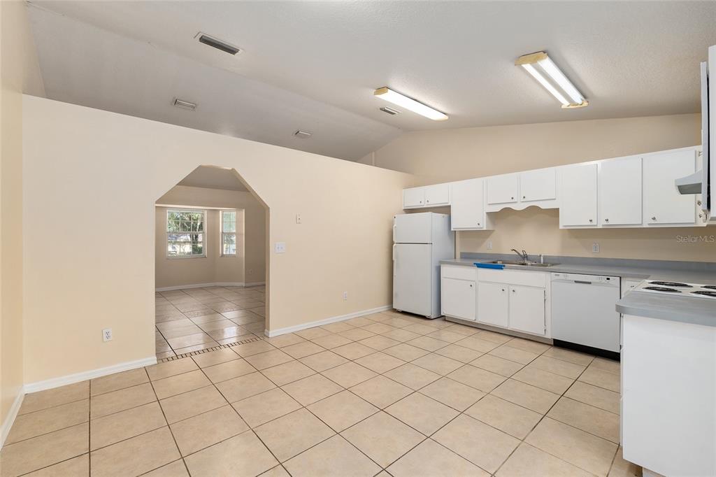 4329 Northwest 155th Street Reddick, FL 32686 - Photo 21 of 52 a kitchen with granite countertop white cabinets and stainless steel appliances
