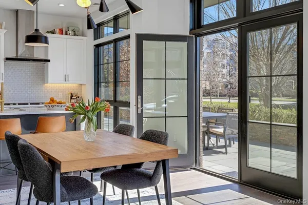 a view of a dining room with furniture and a potted plant