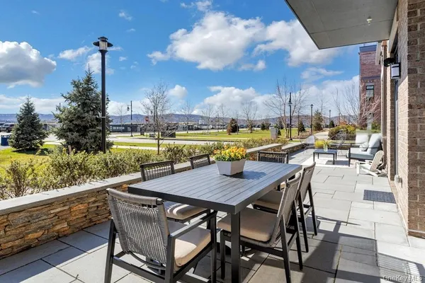 a view of an outside dining space with furniture
