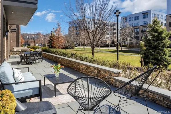 a balcony with table and chairs