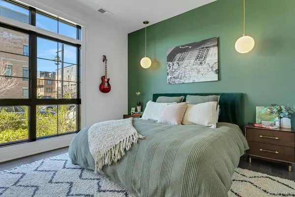 a bed sitting in a bedroom next to a window