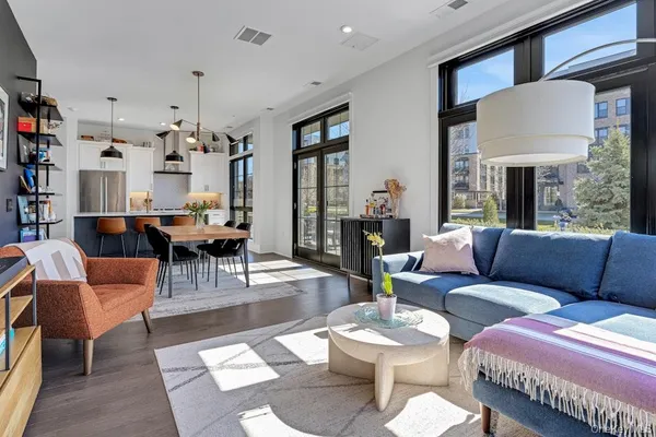 a living room with furniture and a chandelier
