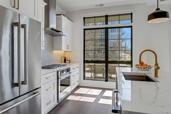 a kitchen with stainless steel appliances granite countertop a stove and a refrigerator