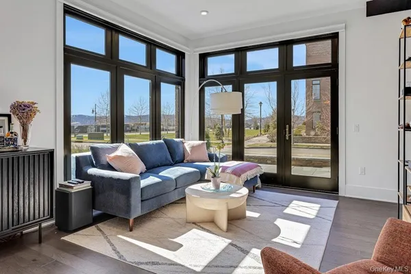 a living room with furniture and a floor to ceiling window