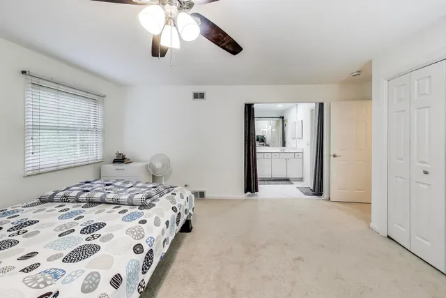 a bedroom with a large bed and a window