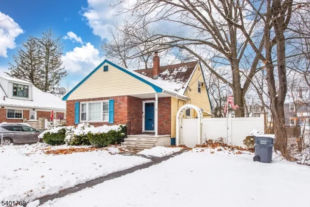 a view of a house with snow on the road