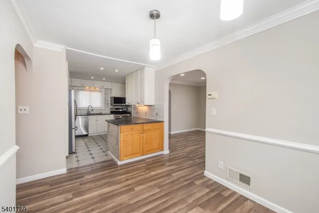 a view of kitchen and refrigerator