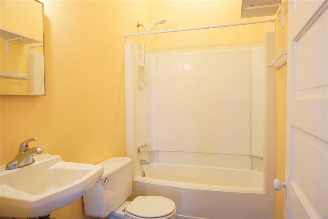 608 West 27th Street Bryan, TX 77803 - Photo 21 of 39 Full bathroom featuring a sink, shower / tub combo, and toilet