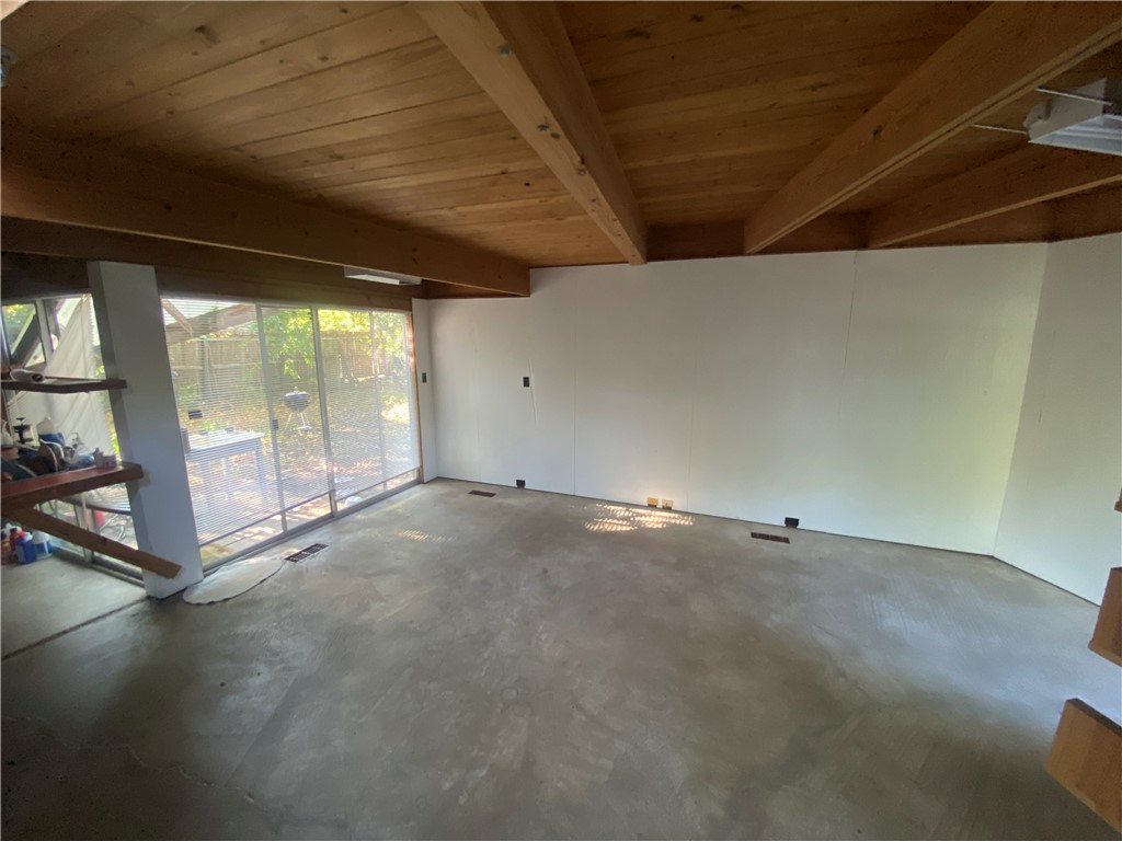 608 West 27th Street Bryan, TX 77803 - Photo 33 of 39 Spare room with unfinished concrete floors and a wood ceiling with exposed beams