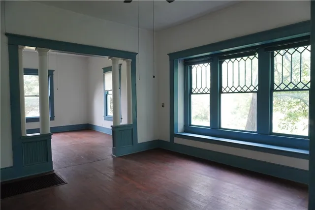 a view of an empty room with large windows