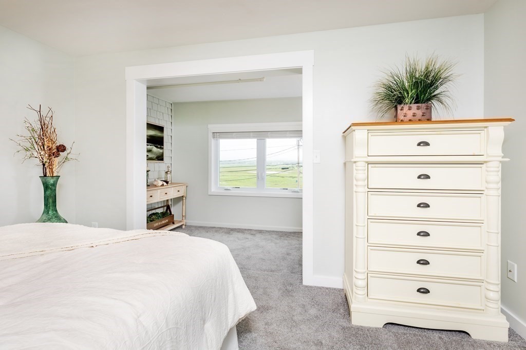 449 Ocean Boulevard, Unit 210 Hampton, NH 03842 - Photo 8 of 13 a bedroom with a bed and a window