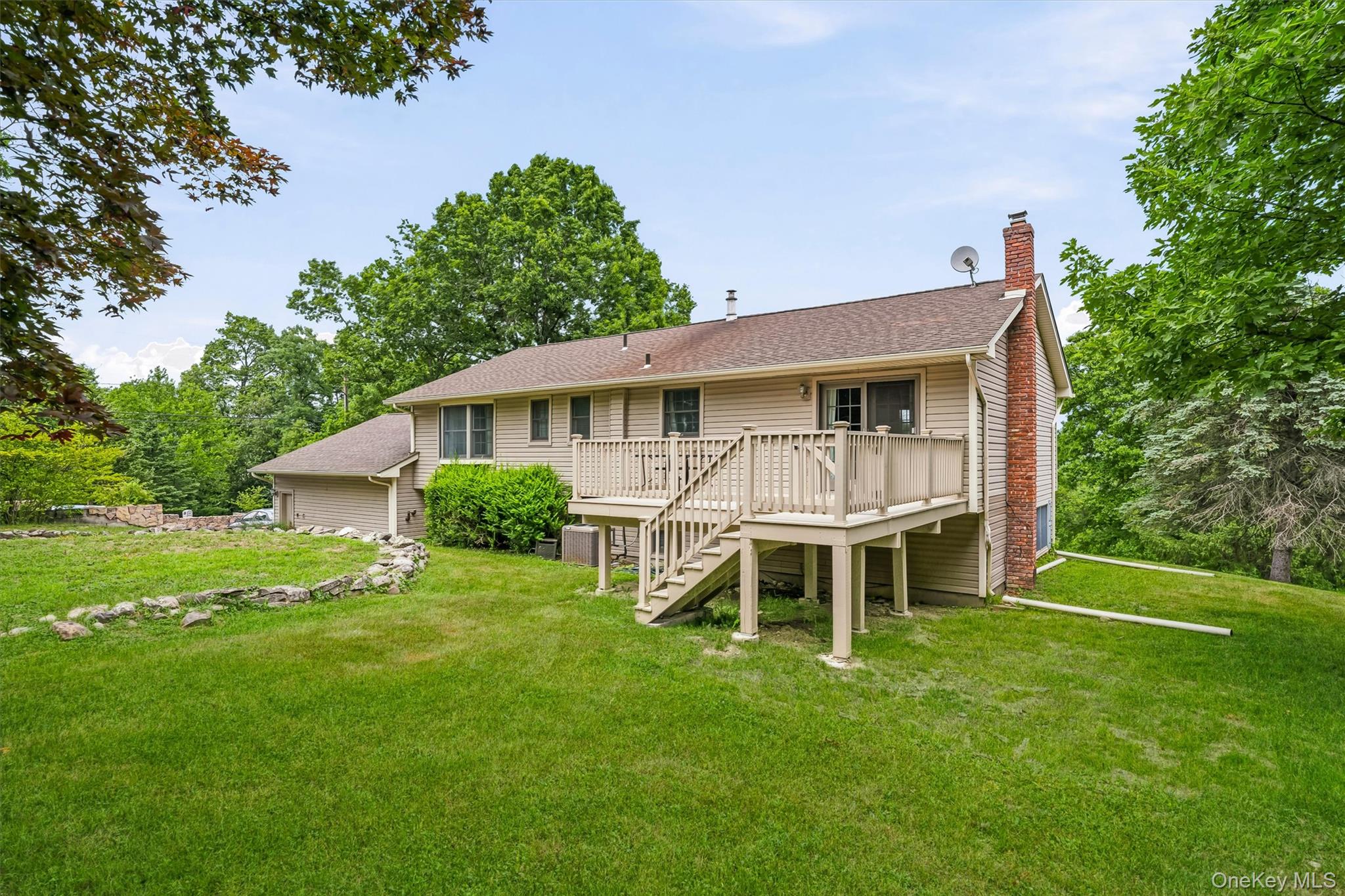 318 Beattie Road Washingtonville, NY 10992 - Photo 34 of 42 a white house with a big yard and more large tree