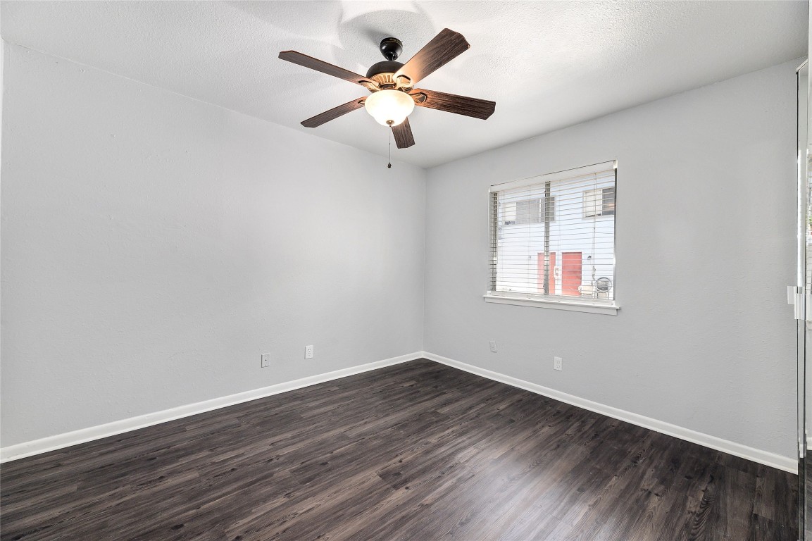 2408 Longview Street, Unit 113 Austin, TX 78705 - Photo 18 of 23 an empty room with wooden floor and ceiling fan