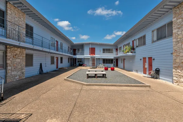 a car parked in front of white building