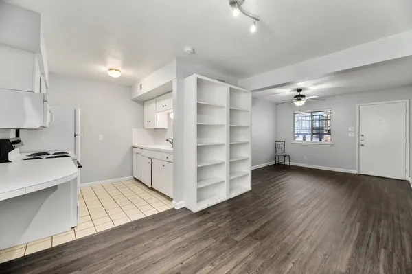 a kitchen with stainless steel appliances cabinets a stove and wooden floors