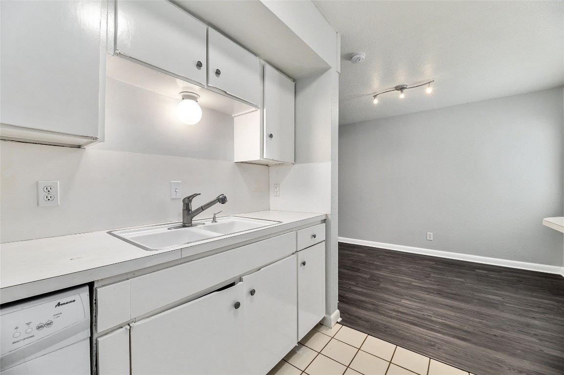 2408 Longview Street, Unit 113 Austin, TX 78705 - Photo 7 of 23 a kitchen with a sink cabinets and wooden floor