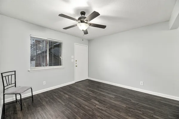 a view of wooden floor and windows in a room