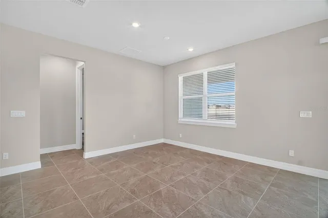 an empty room with windows and closet